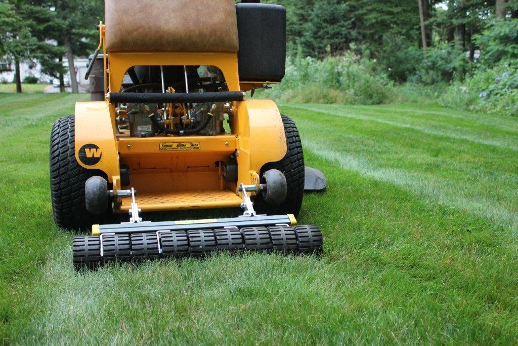 Stand-on mower with a CheckMate lawn striper installed