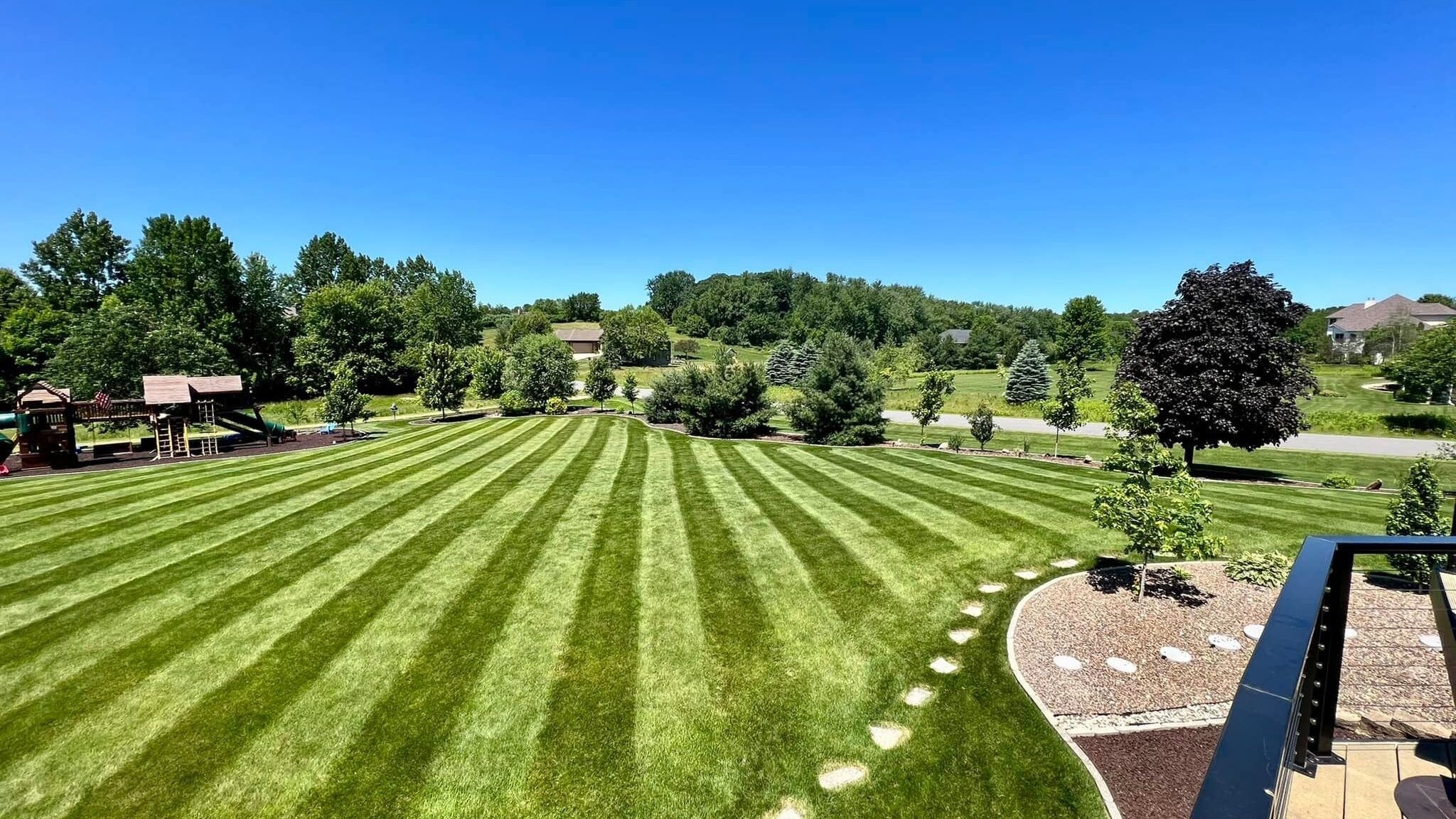 Wide residential lawn with alternating stripes